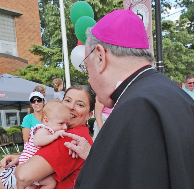 Bishop with baby at Mt. Carmel festival 2015